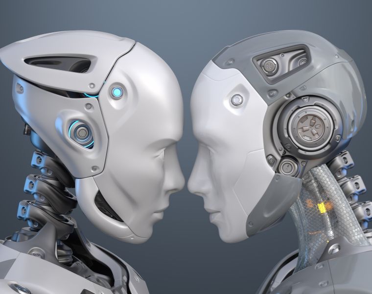 Human-like robots standing face to face. Courtesy of Getty Images.