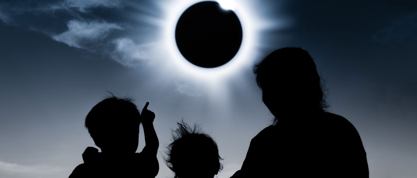 Silhouette of people watching a total solar eclipse