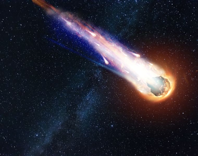 Photo of a comet, asteroid or meteorite falling to the ground against a starry sky. Courtesy of Getty Images.