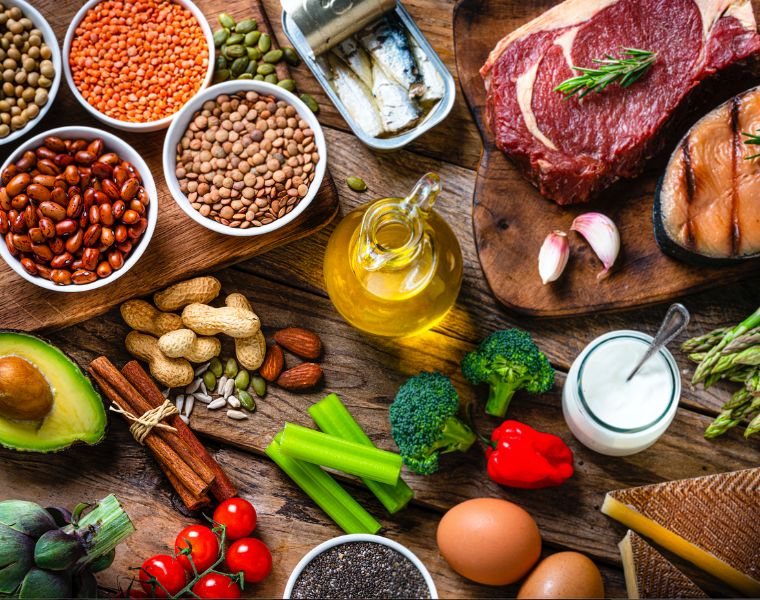 Fresh healthy organic food for balanced diet on wooden table. Courtesy of Getty Images.