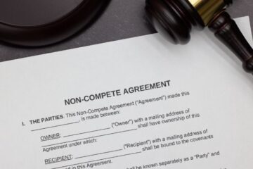 Close up of non-compete agreement form with a gavel. Courtesy of Getty Images.