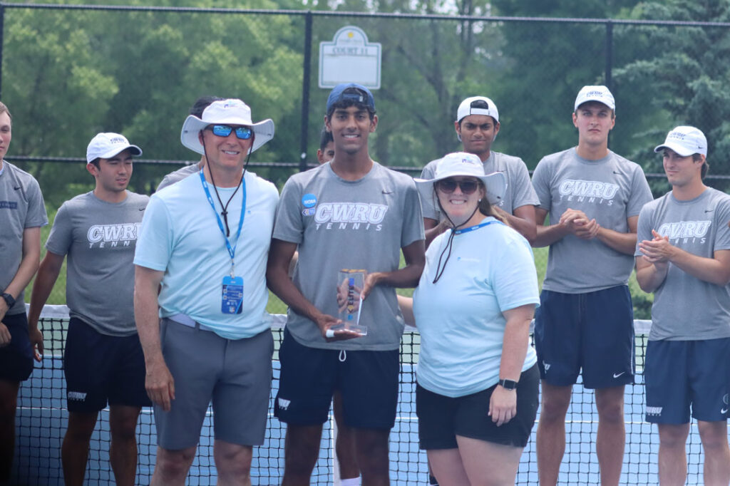 Photo of Sahil Dayal and his coaches and teammates posing with his Elite 90 trophy