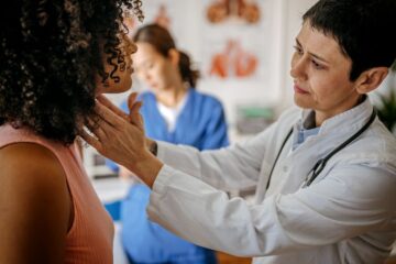 Photo of a doctor examining a patient. Courtesy of Getty Images.