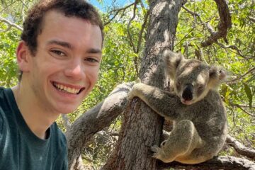 Photo of Carson Williams posing with a koala.