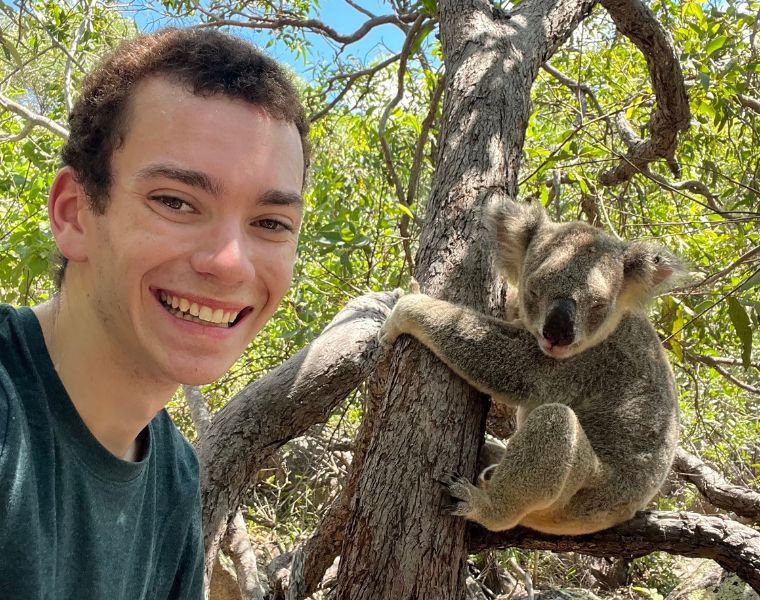 Photo of Carson Williams posing with a koala.