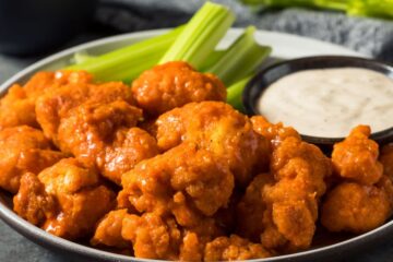 Close up of homemade fried boneless buffalo chicken wings with ranch dressing.