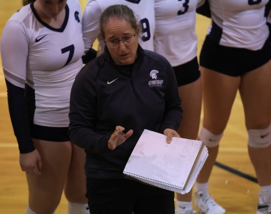 Karen Farrell coaching volleyball players during game