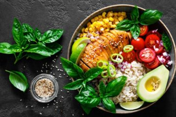 Grilled chicken breast lunch bowl with fresh tomato, avocado, corn, red onion, rice and basil. Courtesy of Getty Images.