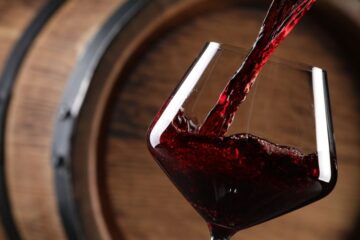 Close up of red wine being poured into a glass. Courtesy of Getty Images