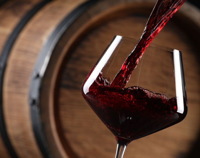 Close up of red wine being poured into a glass. Courtesy of Getty Images