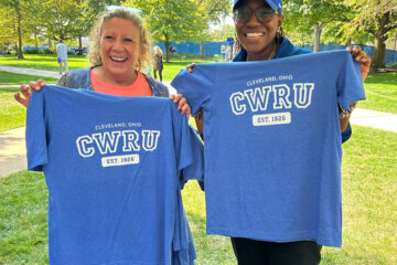 Photo of two CWRU staff members holding up their BlueCWRU T-shirts