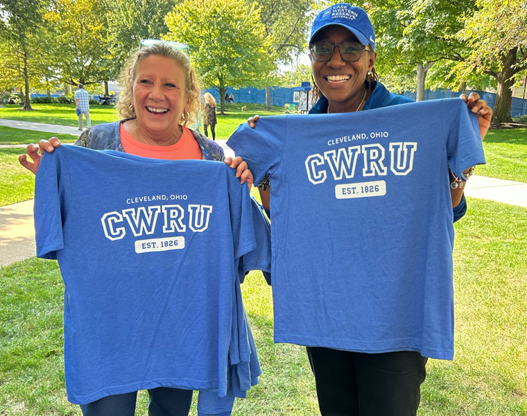 Photo of two CWRU staff members holding up their BlueCWRU T-shirts