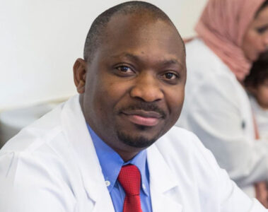 Photo of Fredrick Kizito in a lab coat