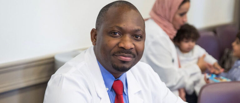 Photo of Fredrick Kizito in a lab coat