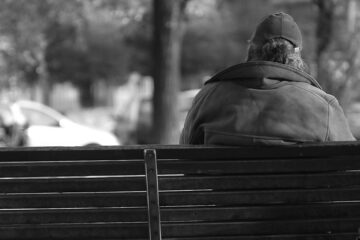 Homeless man on a park bench