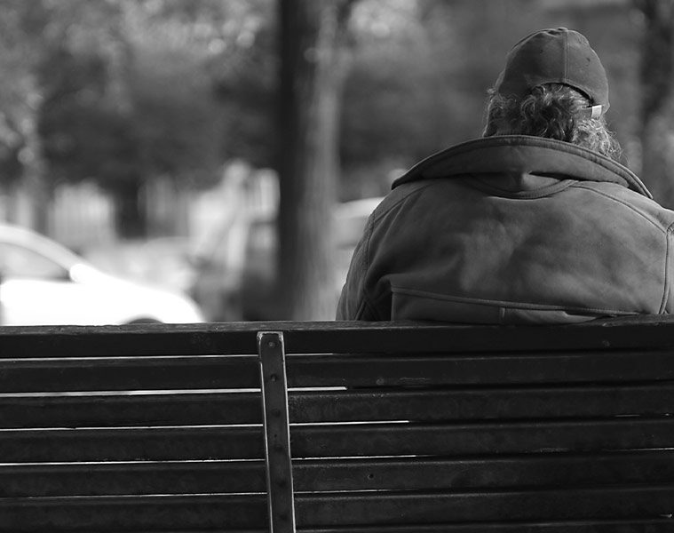 Homeless man on a park bench