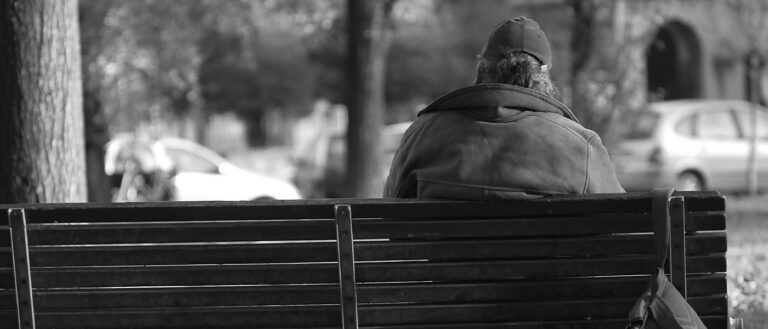 Homeless man on a park bench