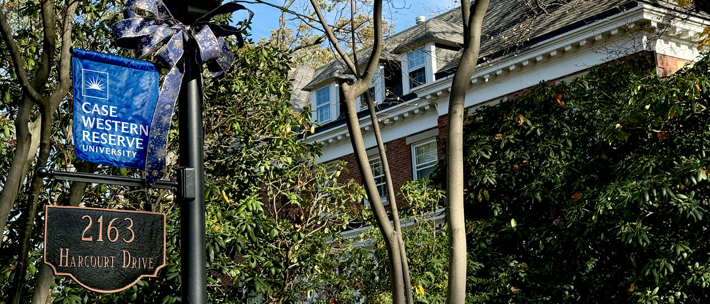 Photo of the light post outside Harcourt House decorated with a blue bow with the home in the background