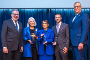 President Kaler and Vice President Michael Oakes pose with this year's Faculty Distinguished Research Award winners.