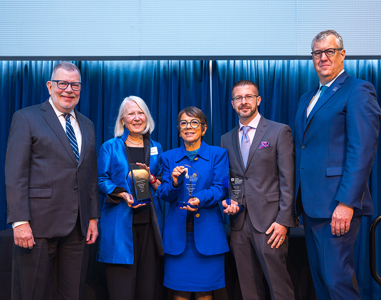 President Kaler and Vice President Michael Oakes pose with this year's Faculty Distinguished Research Award winners.