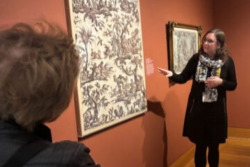 Photo of Jillian Kruse talking about a artwork on display