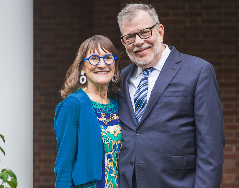 Photo of Mrs. Kaler and President Eric Kaler posing on the front porch of Harcourt House