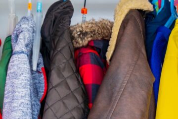 Close up of winter coats hanging on a rack. Courtesy of Getty Images