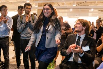 Participants smile and applaud at the Morgenthaler-Pavey Startup Competition.