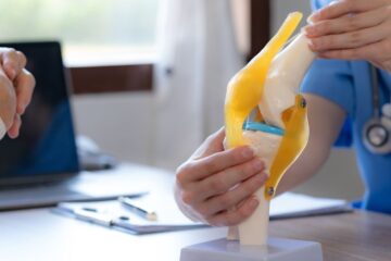 Female doctor who is explaining the treatment method of the knee joint to the woman patient