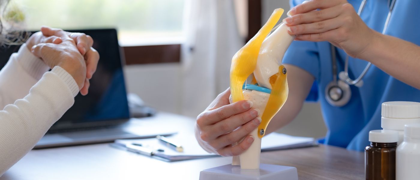 Female doctor who is explaining the treatment method of the knee joint to the woman patient