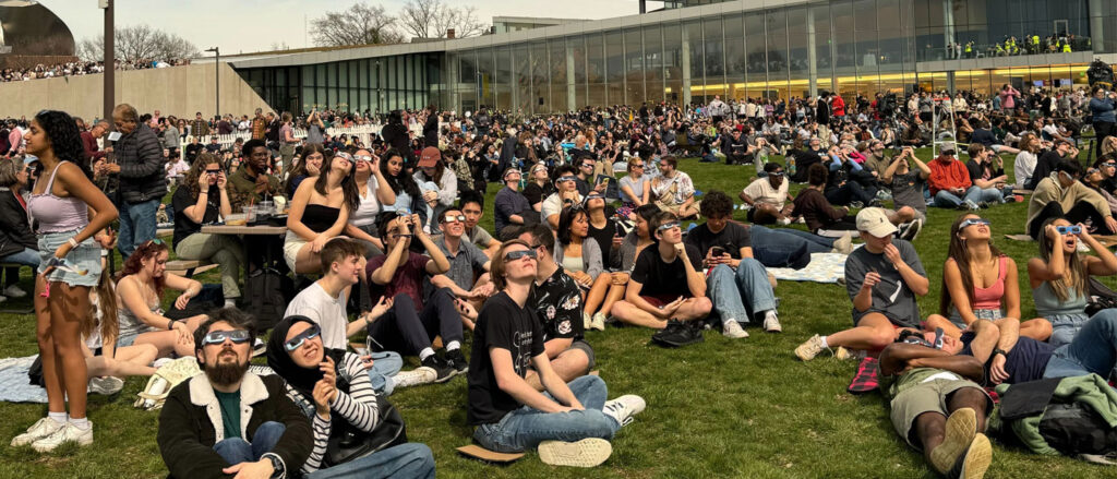 Photo of members of the CWRU community watching the solar eclipse outside Tinkham Veale University Center