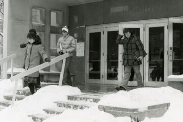 CWRU Archives photo of students exiting Sears Library Building during a snowstorm in the 1970-80s