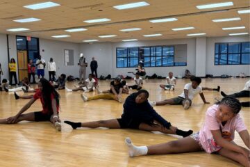 NYSP participants stretching in a gym.